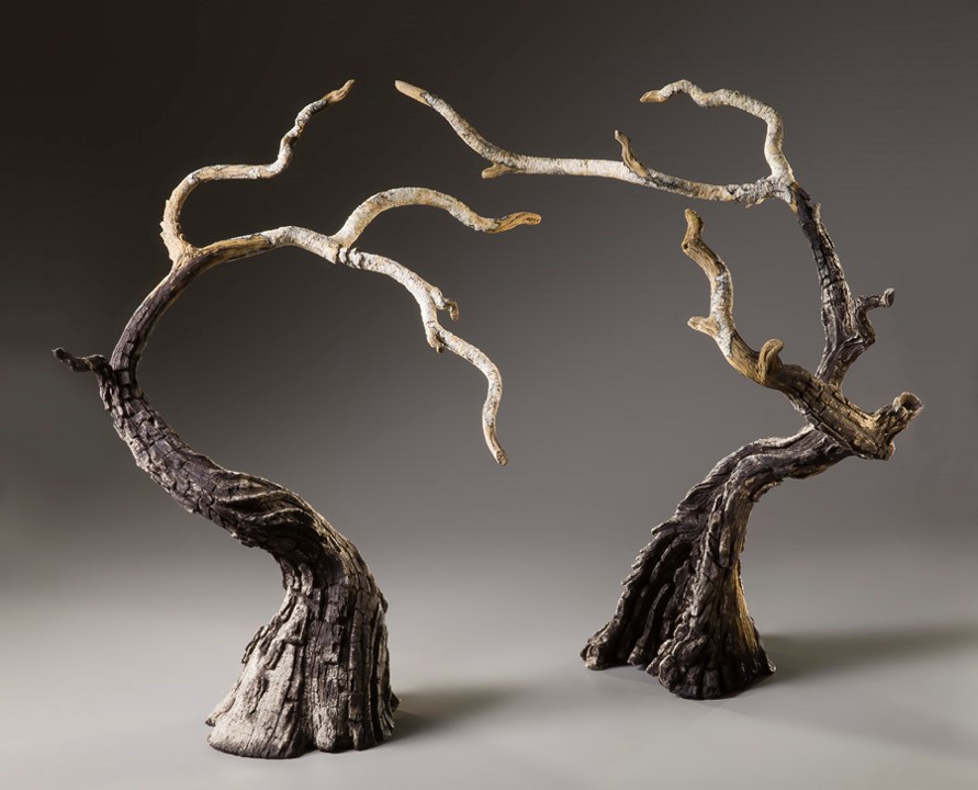 Eric Serritella, Whisper & Wander (2016). Ceramic. Dimensions: 32” h x 56” w x 32” d.  ©2016 Eric Serritella. Photographer: Jason Dowdle. Courtesy of the artist.  Serritella’s sculpture captures the interaction between two charred trees struggling to survive the aftermath of a wildfire. Whisper’s quiet negative space hints at remaining life. Wander seeks a gap in the canopy for more light to grow.   Their fates are intertwined because survival depends on the health of the forest ecosystem. Whisper and Wander can support and nourish each other through a “wood wide web” of interconnected roots and fungi to assure mutual survival.  