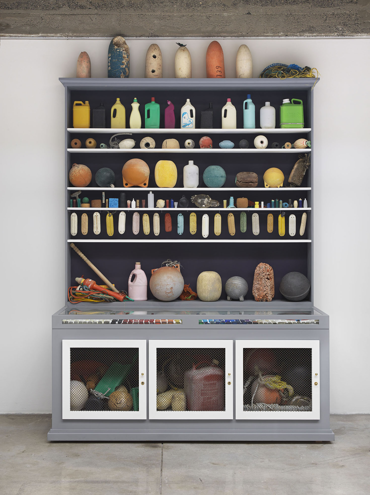 Mark Dion, <em>Cabinet of Marine Debris, </em>2014. Wood and metal cabinet, marine debris, plastic, rope. 113 x 84 x 32 inches. ©2014 Mark Dion. Margulies Collection, Miami. Courtesy of American Federation of Arts and The Bruce Museum.